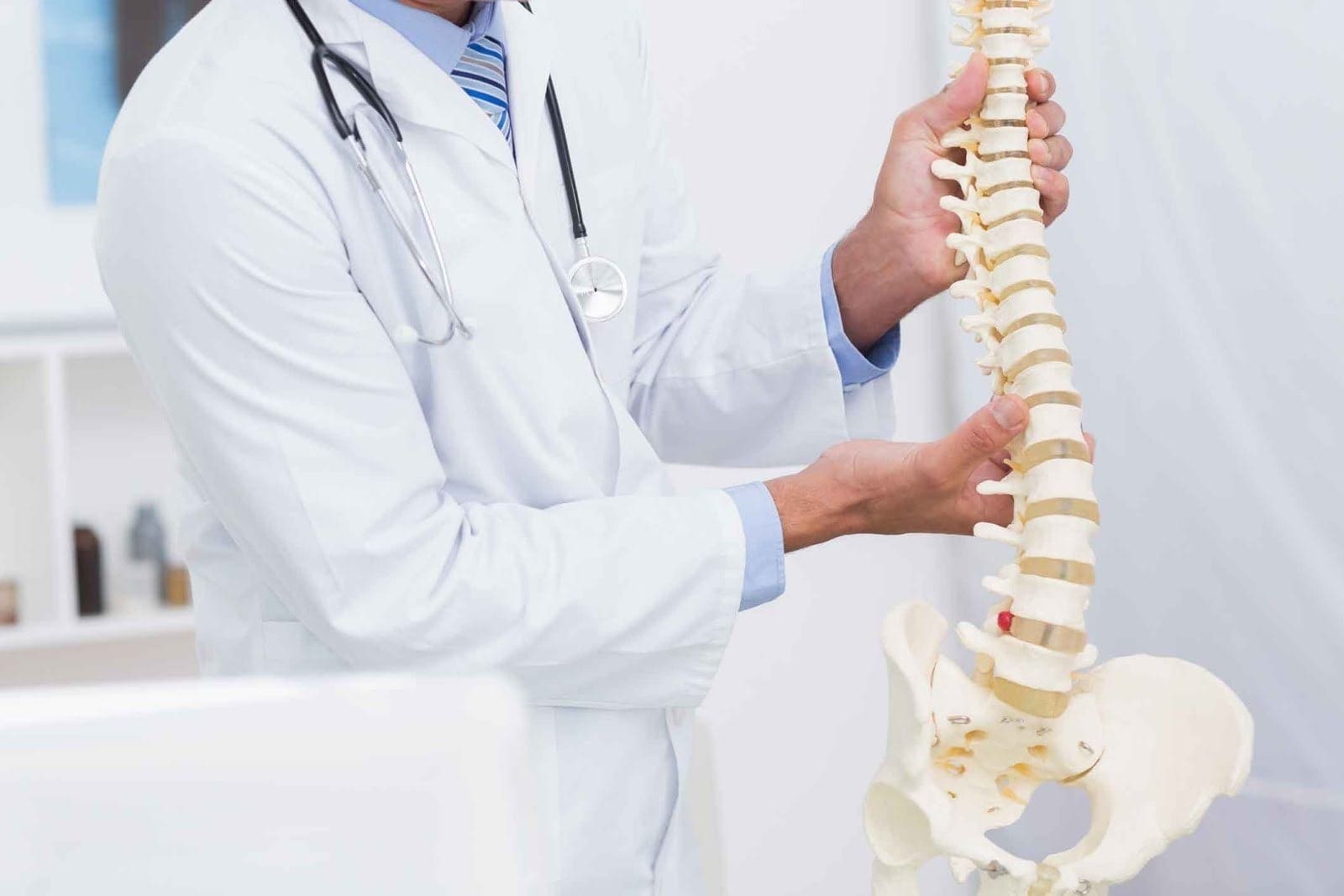 Image of a doctor demonstrating degenerative disc disease to a patient.